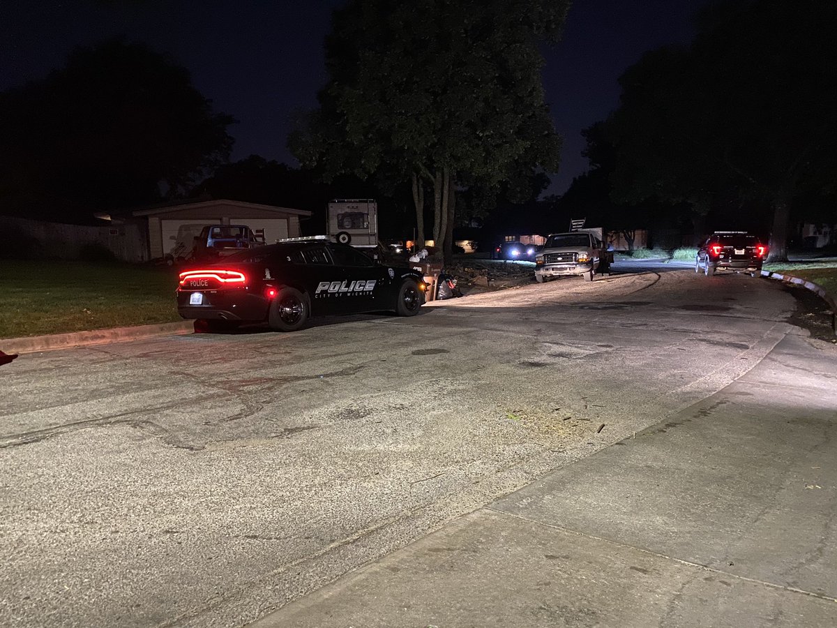 Police have put crime scene tape & set up a partition in front of the home where the shooting took place.   man is killed in a shooting near Parkwood & 13th, between Woodlawn & Oliver in Wichita.