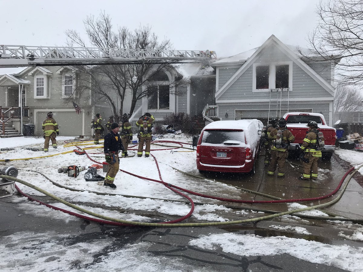 @OlatheFire continues to put water on a house fire. A captain said lots of stuff inside fueled the fire, causing it to spread  Firefighters rescued 1 adult from the front window. 2 other adults and a teenager escaped on their own. All are at the hospital and are stable