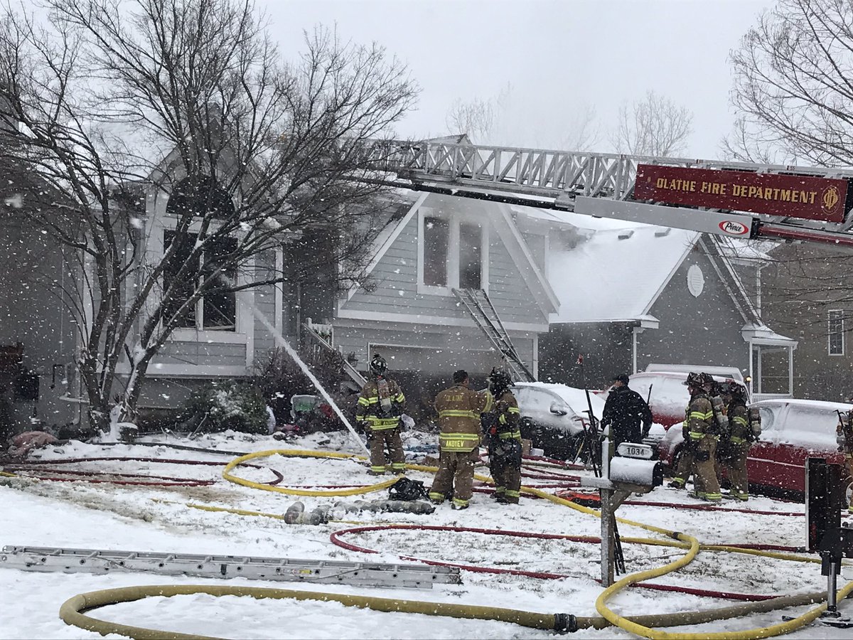 @OlatheFire continues to put water on a house fire. A captain said lots of stuff inside fueled the fire, causing it to spread  Firefighters rescued 1 adult from the front window. 2 other adults and a teenager escaped on their own. All are at the hospital and are stable